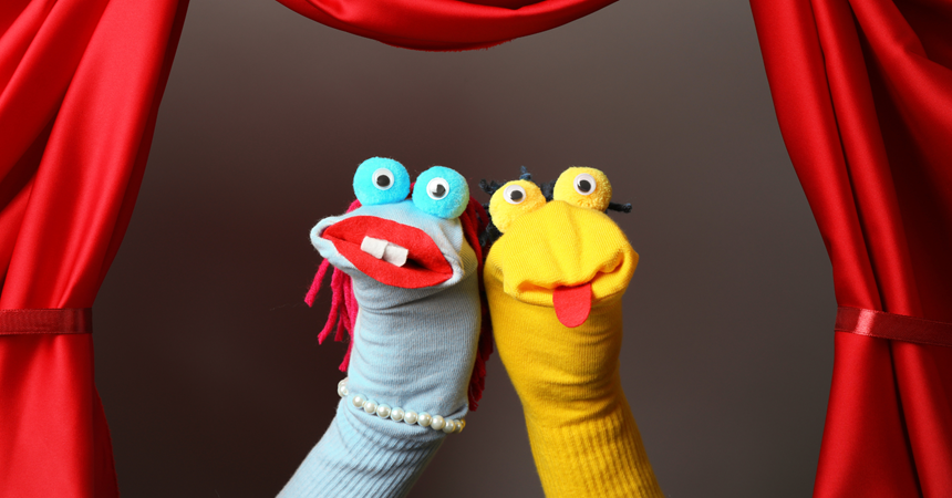 Two hand puppets made from socks and googly eyes.
