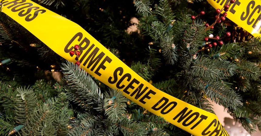 A Christmas tree wrapped in "Crime Scene: Do Not Cross" warning tape.