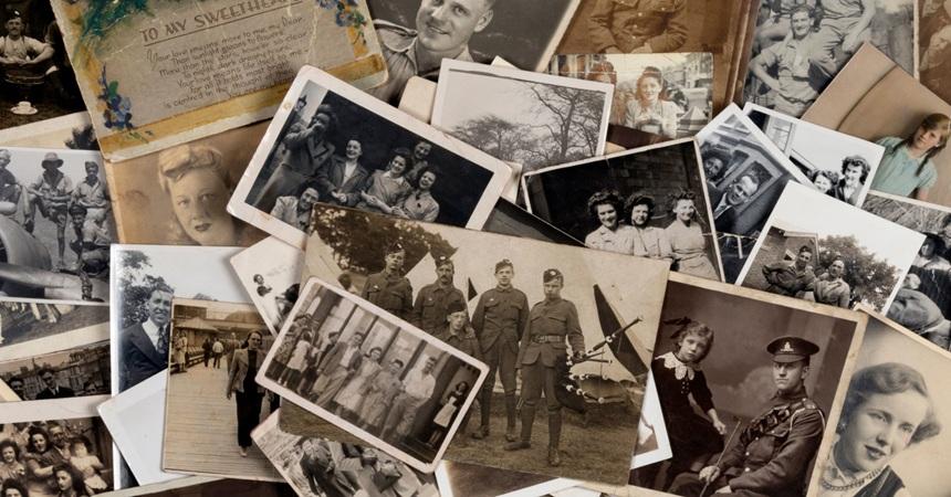 An unsorted, messy pile of loose black-and-white photos.