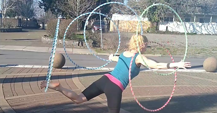 Shanda Button, aka "The Hula Hoop Beast," twirls two hula hoops on each arm, plus one on each leg.