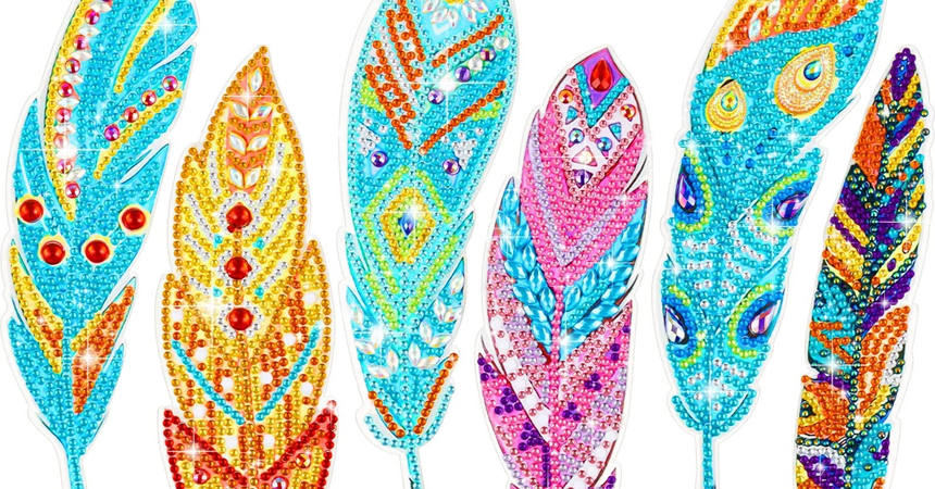 Six feather-shaped bookmarks, covered in "Rhinestone" style gem stickers.