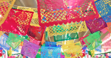 Several banners of "papel picado" - the Mexican art form of cutting intricate patterns into colorful tissue paper.