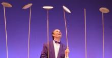 Performer Henrik Bothe keeps five dinner plates spinning atop thin poles.