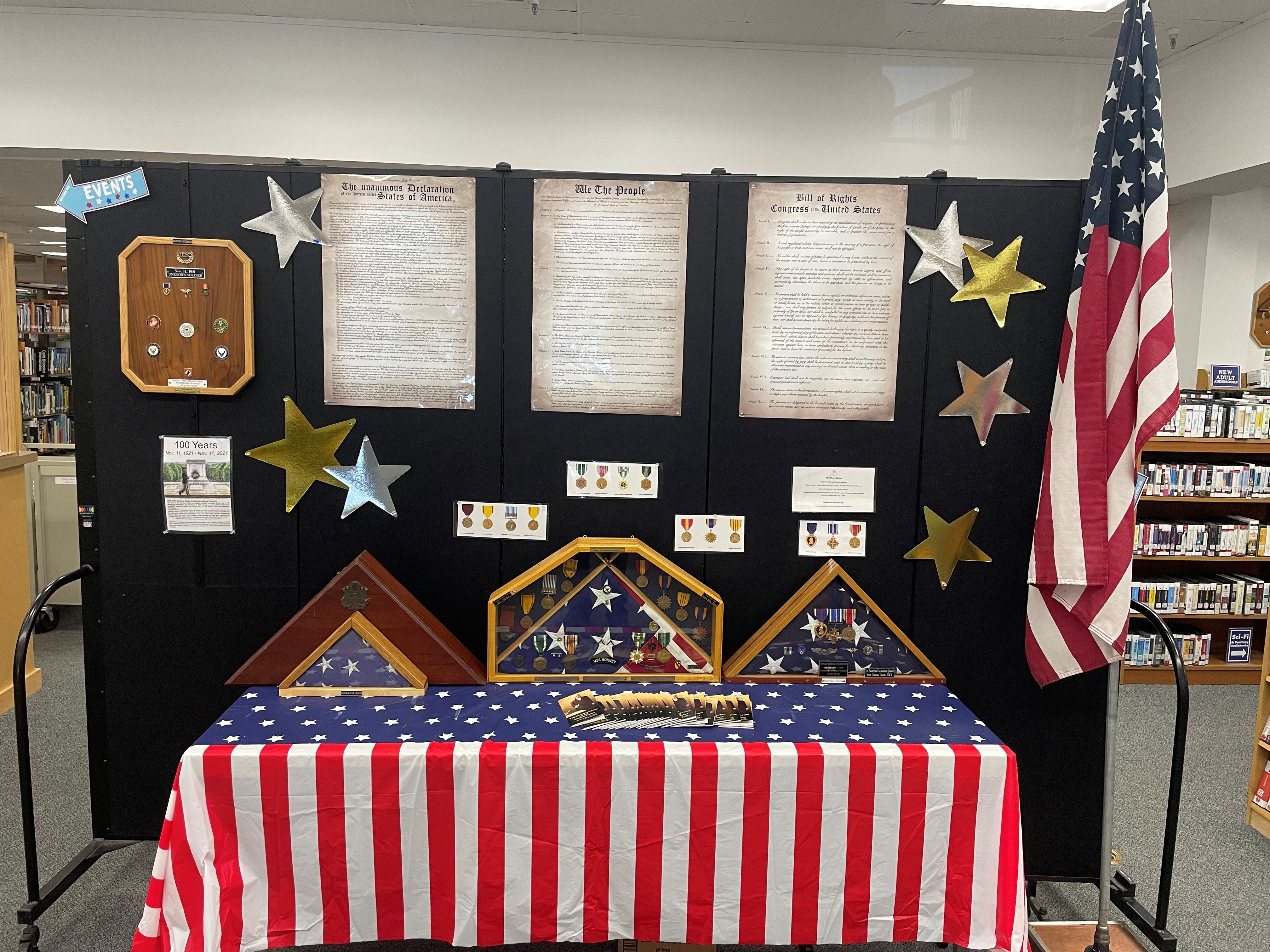 A photo of the America 250 display at the downtown Klamath County Library, including posters with the full texts of the Declaration of Independence, the Preamble to the Constitution, and the Bill of Rights.